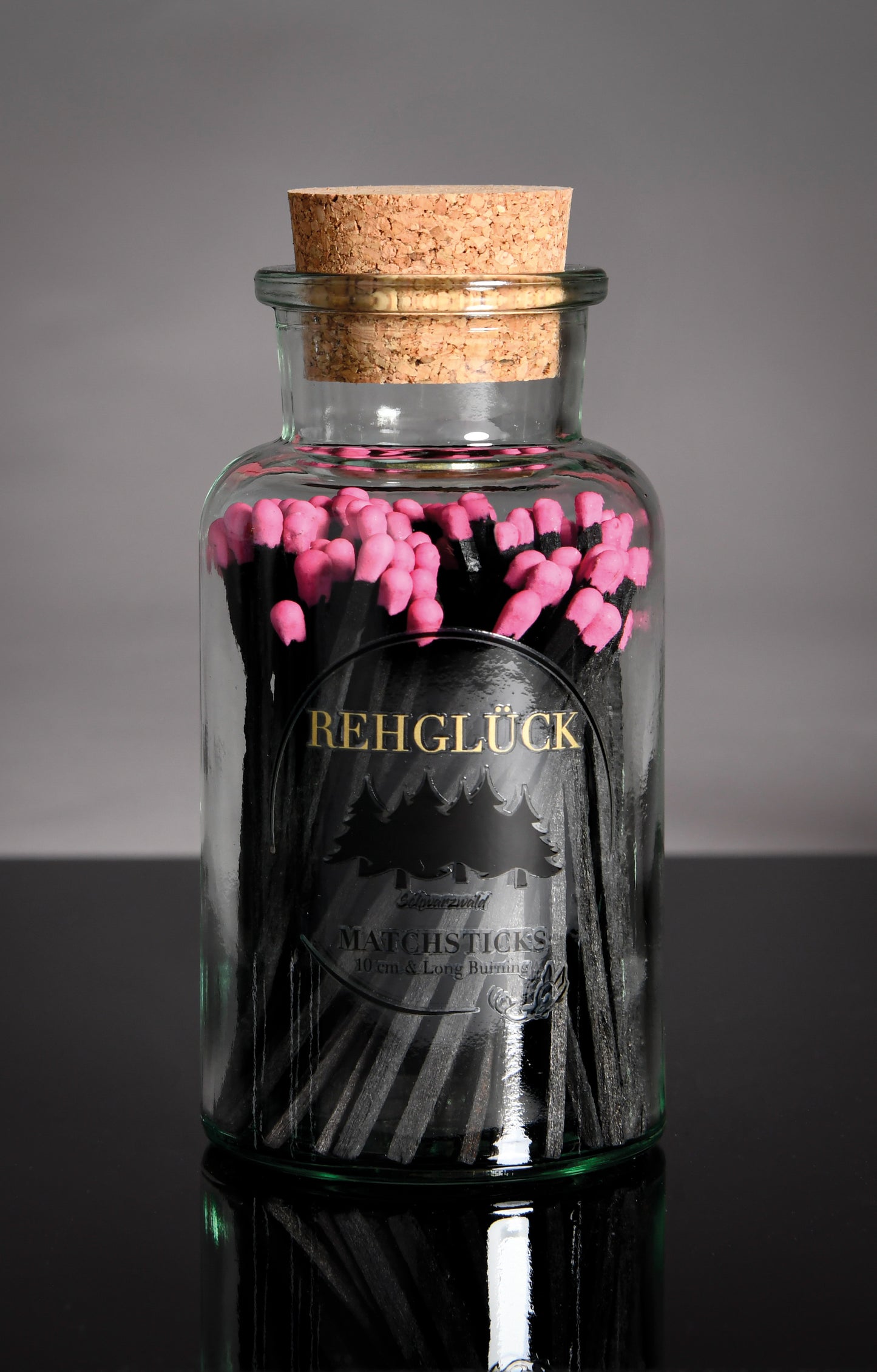 Apothekerflasche mit schwarzen Streichhölzern/Pink