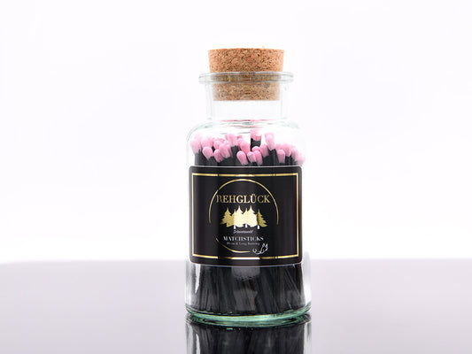 Apothekerflasche mit schwarzen Streichhölzern/Rosa