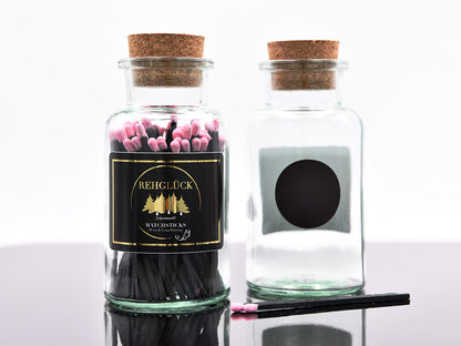 Apothekerflasche mit schwarzen Streichhölzern/Rosa
