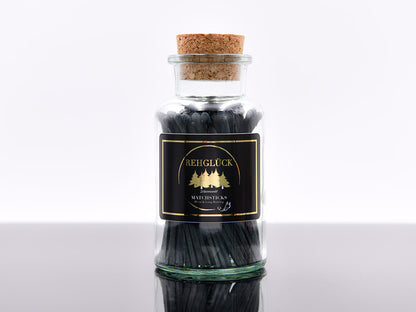 Apothekerflasche mit schwarzen Streichhölzern
