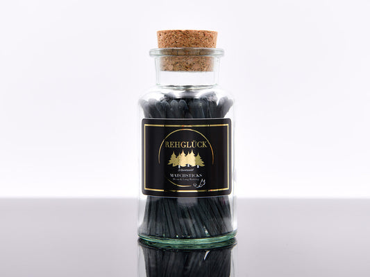 Apothekerflasche mit schwarzen Streichhölzern