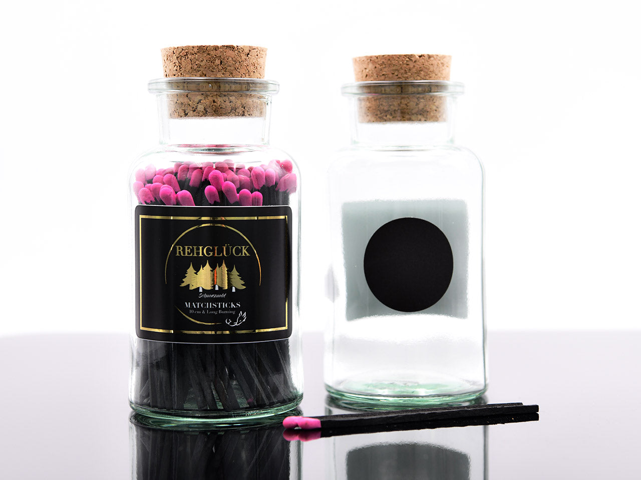 Apothekerflasche mit schwarzen Streichhölzern/Pink