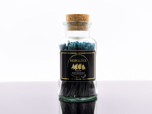 Apothekerflasche mit schwarzen Streichhölzern/Blau