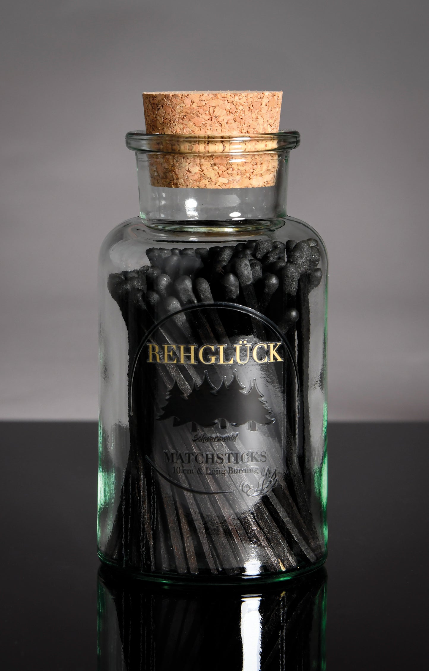 Apothekerflasche mit schwarzen Streichhölzern