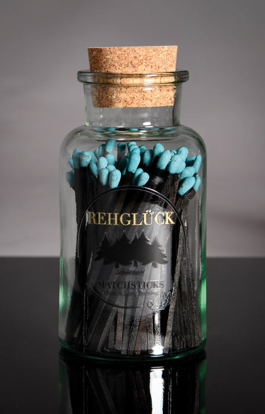 Apothekerflasche mit schwarzen Streichhölzern/Blau