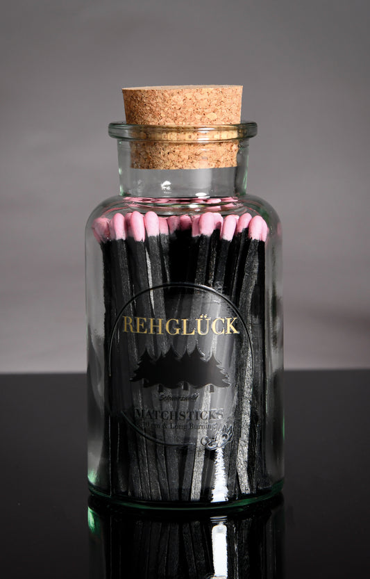 Apothekerflasche mit schwarzen Streichhölzern/Rosa