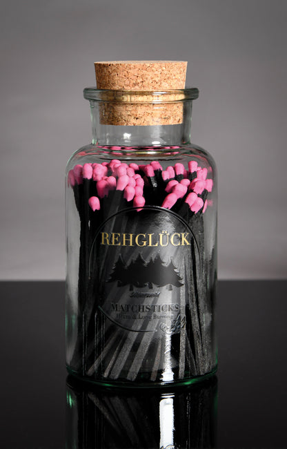 Apothekerflasche mit schwarzen Streichhölzern/Pink