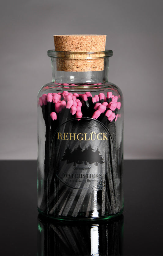 Apothekerflasche mit schwarzen Streichhölzern/Pink
