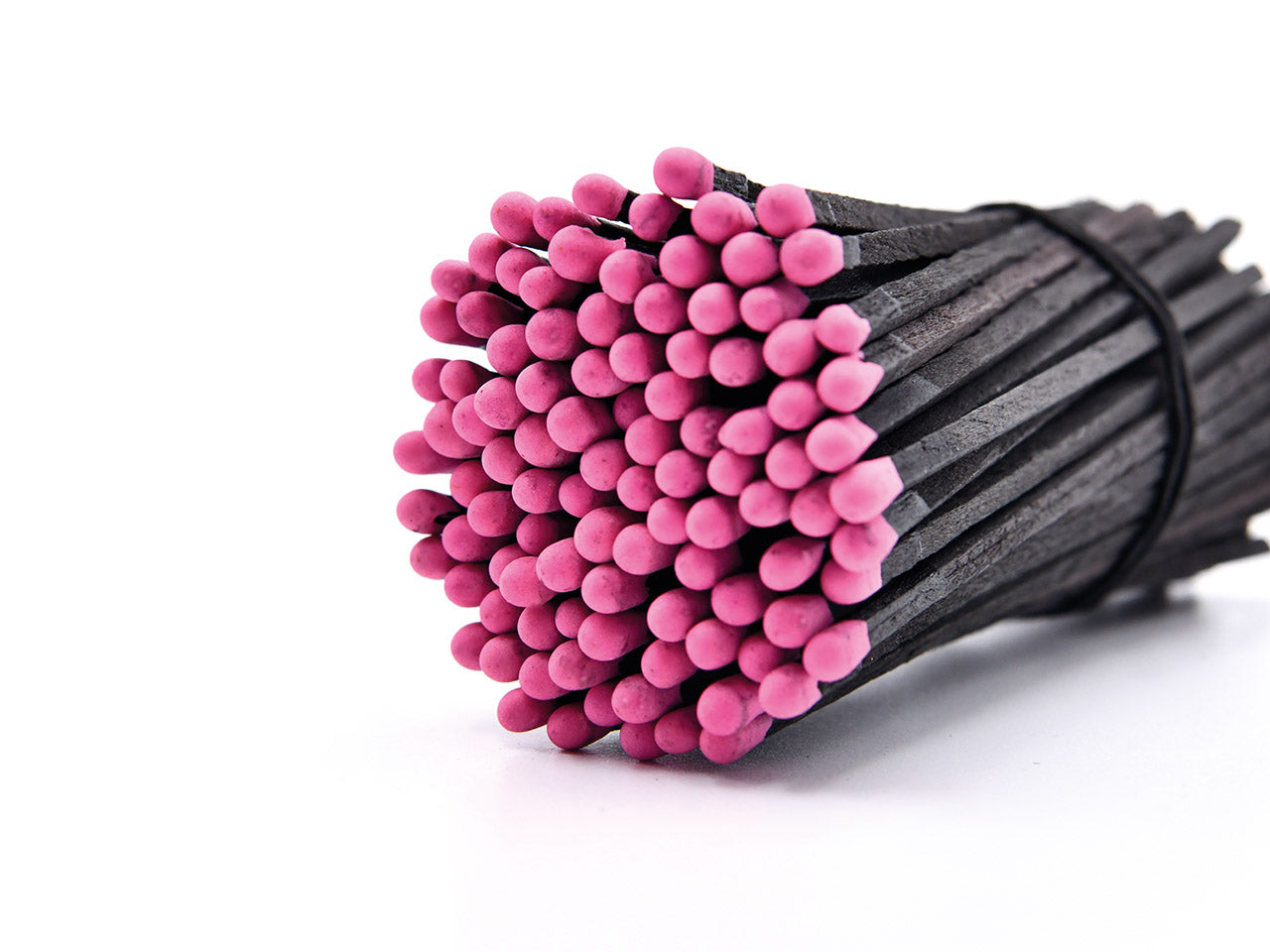 Zylinderglas schwarze Streichhölzer/pinker Kopf