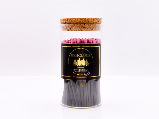 Zylinderglas schwarze Streichhölzer/pinker Kopf