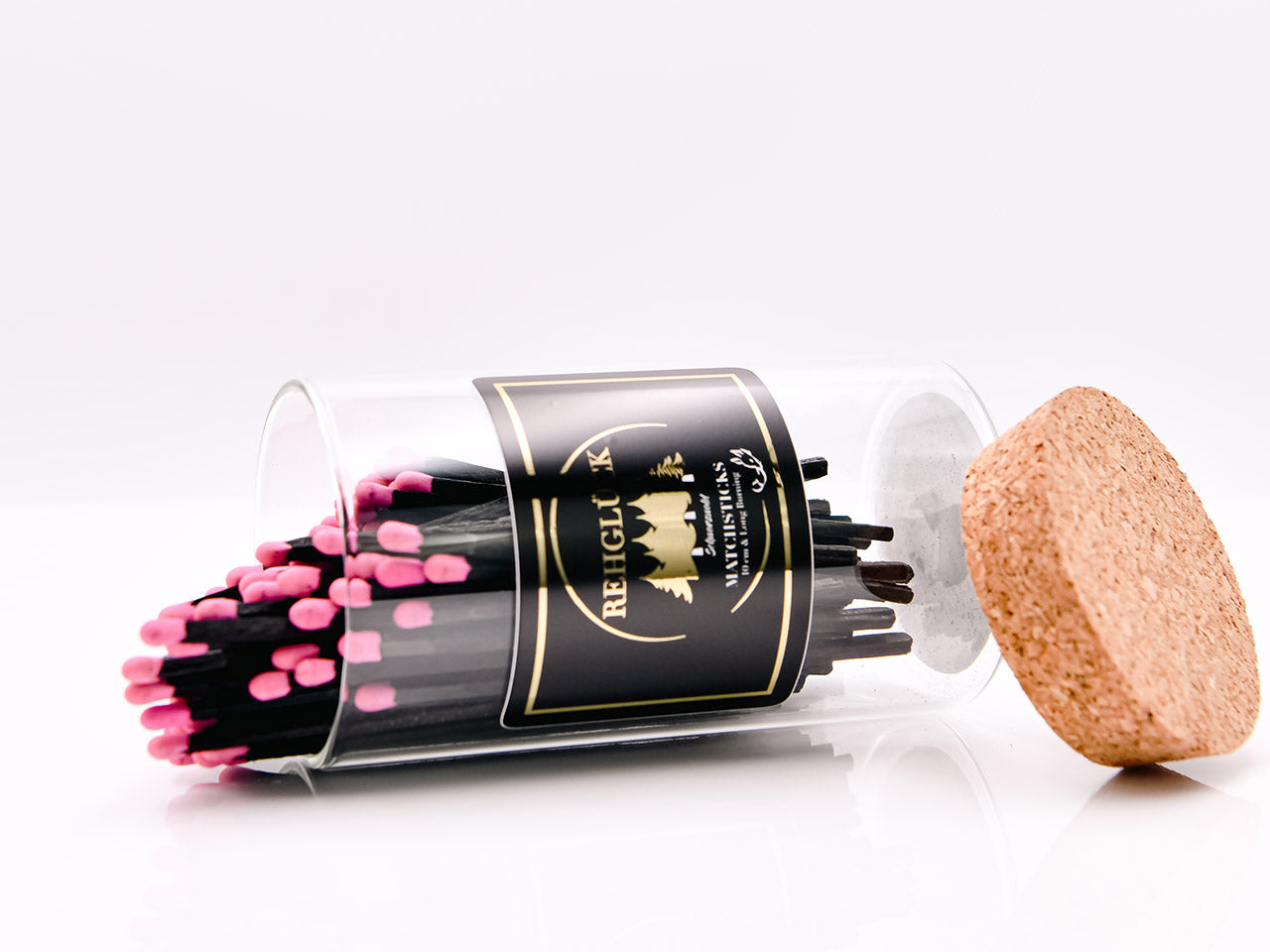 Zylinderglas schwarze Streichhölzer/pinker Kopf